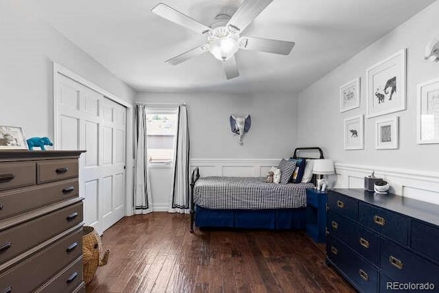 5955 Blue Sage Way, Littleton, CO 80123 - bedroom with dark wood-style floors, a wainscoted wall, a closet, and a ceiling fan