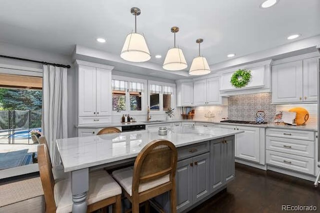 5955 Blue Sage Way, Littleton, CO 80123 - kitchen with gray cabinets, white cabinetry, tasteful backsplash, a kitchen island, and recessed lighting