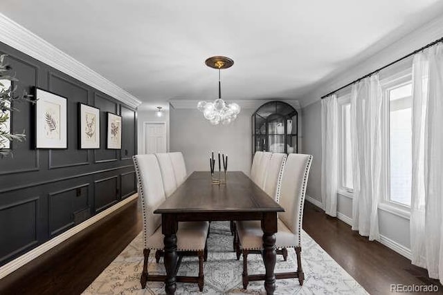 5955 Blue Sage Way, Littleton, CO 80123 - dining space with a chandelier, wood finished floors, and ornamental molding
