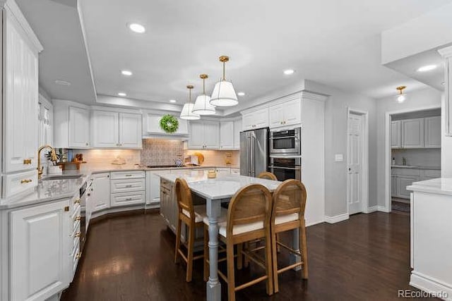 5955 Blue Sage Way, Littleton, CO 80123 - kitchen featuring appliances with stainless steel finishes, white cabinetry, dark wood-type flooring, tasteful backsplash, and recessed lighting