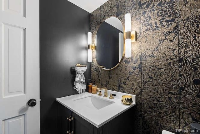 5955 Blue Sage Way, Littleton, CO 80123 - bathroom with vanity, wallpapered walls, and vaulted ceiling