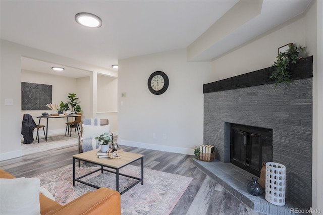 living room with hardwood / wood-style floors and a fireplace