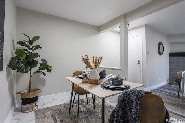 dining space with wood-type flooring