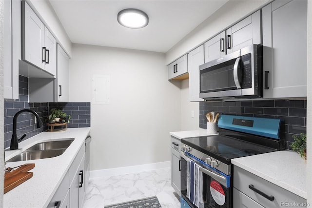 kitchen featuring stainless steel appliances, backsplash, sink, and light tile floors