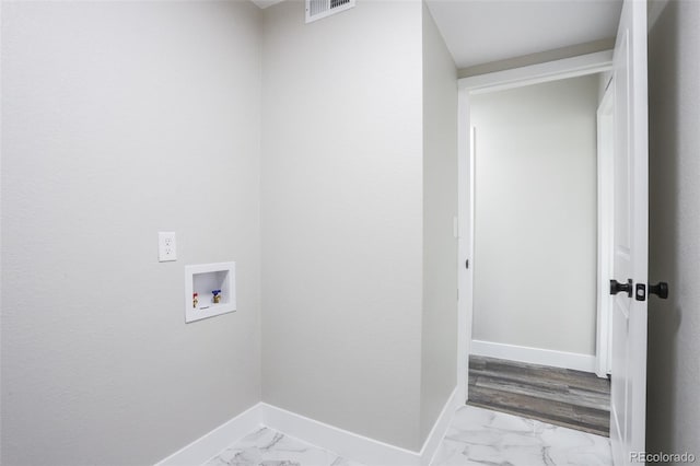 clothes washing area with tile flooring and washer hookup