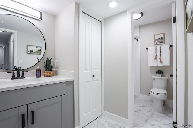 bathroom with tile floors, large vanity, and toilet