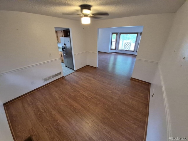 3136 S Cathay Cir, Aurora, CO 80013 - spare room featuring ceiling fan, a textured ceiling, wood finished floors, and baseboards