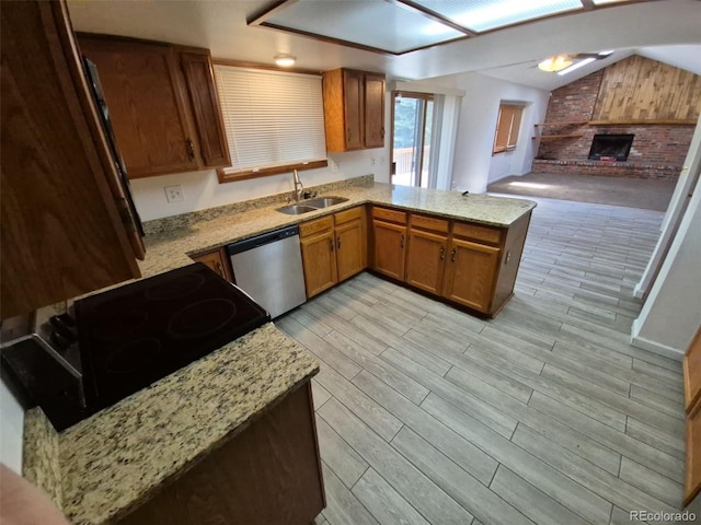 3136 S Cathay Cir, Aurora, CO 80013 - kitchen with stainless steel dishwasher, a sink, a peninsula, light wood-style floors, and a brick fireplace