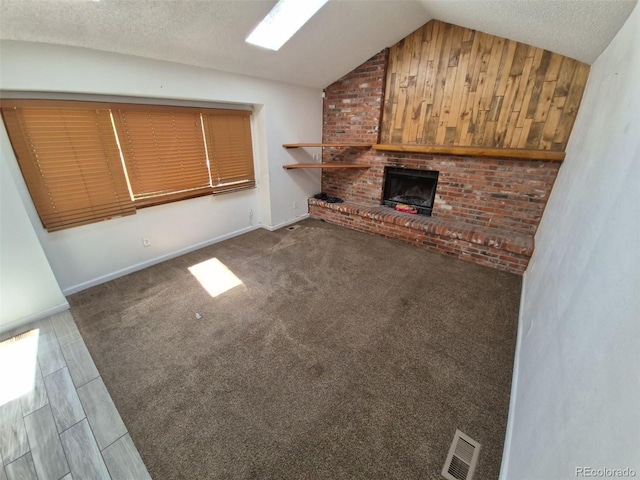 3136 S Cathay Cir, Aurora, CO 80013 - unfurnished living room featuring vaulted ceiling, a fireplace, and a textured ceiling