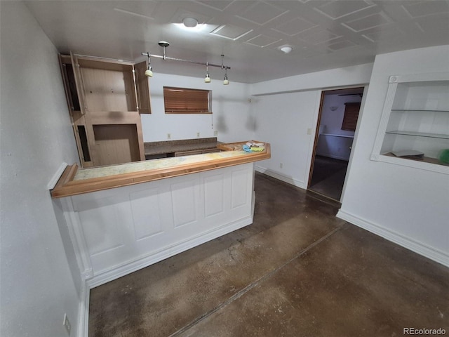 3136 S Cathay Cir, Aurora, CO 80013 - kitchen with finished concrete flooring, built in shelves, baseboards, and butcher block countertops