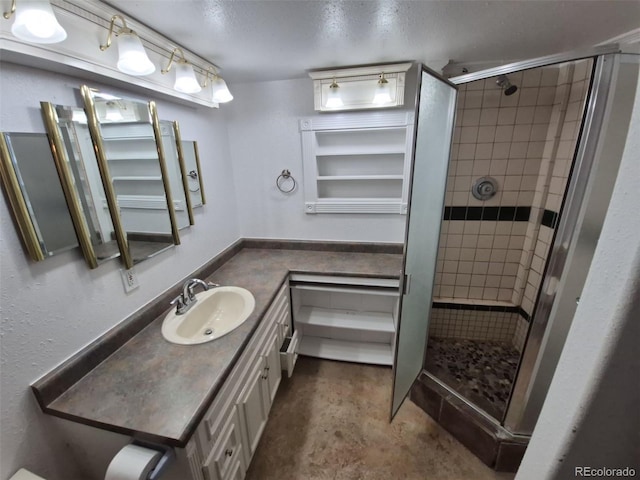 3136 S Cathay Cir, Aurora, CO 80013 - bathroom with vanity, a stall shower, concrete floors, and a textured ceiling