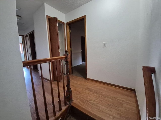 3136 S Cathay Cir, Aurora, CO 80013 - stairs featuring wood finished floors, baseboards, and a textured wall