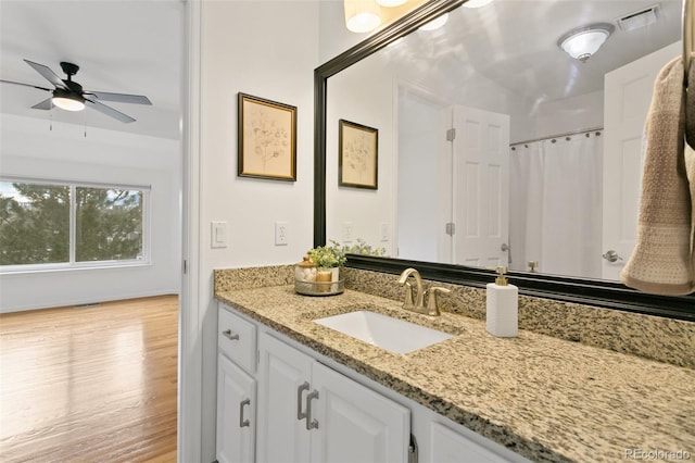 bathroom with hardwood / wood-style flooring, ceiling fan, vanity, and a shower with curtain
