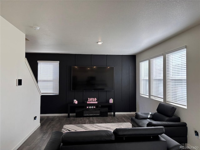 living room with wood-type flooring and a textured ceiling