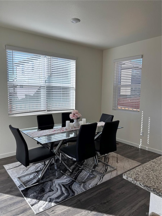 dining area featuring dark hardwood / wood-style floors and a healthy amount of sunlight