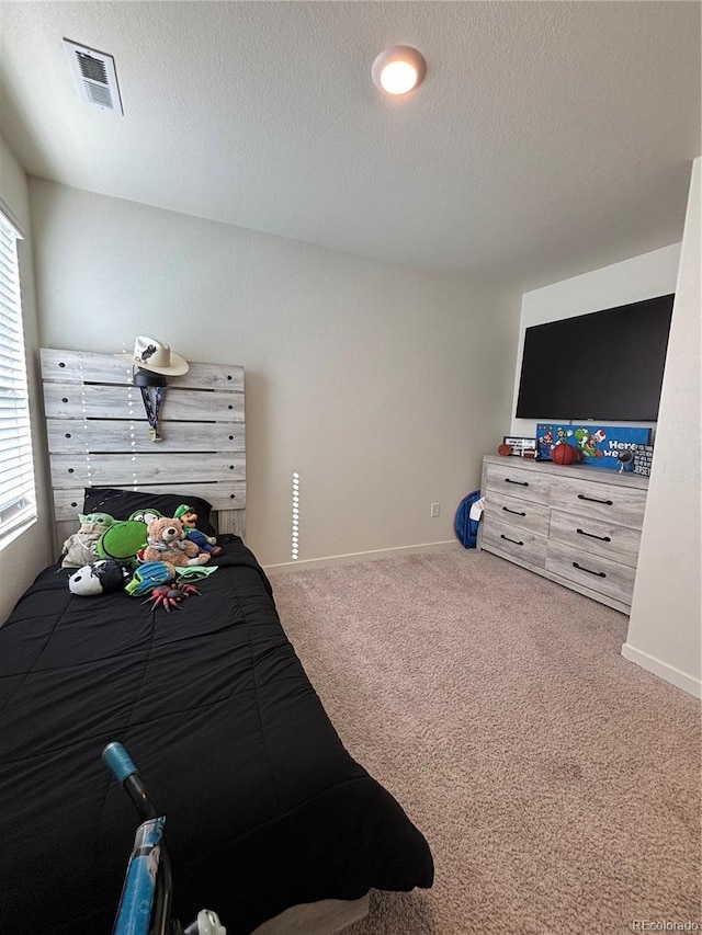 carpeted bedroom with a textured ceiling