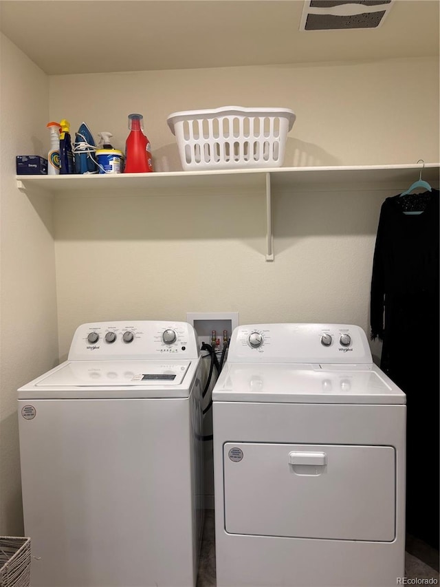 washroom featuring washer and clothes dryer