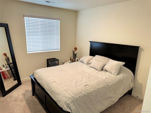 bedroom with light colored carpet