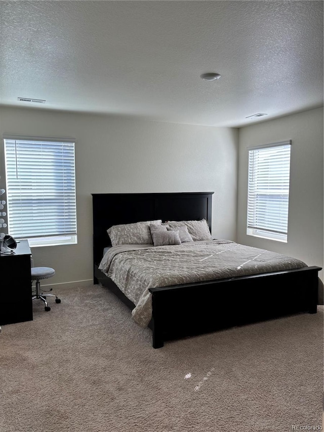 carpeted bedroom featuring a textured ceiling