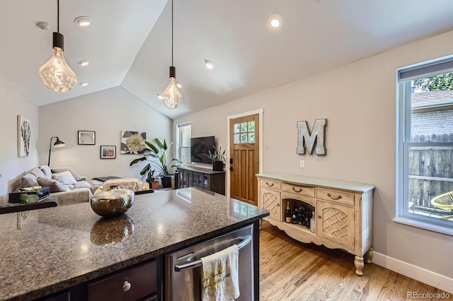 2841 N Columbine St, Denver, CO 80205 - kitchen featuring light wood finished floors, open floor plan, healthy amount of natural light, lofted ceiling, and pendant lighting