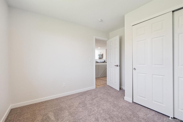 1718 S Flanders Way, Aurora, CO 80017 - unfurnished bedroom with light carpet and a closet