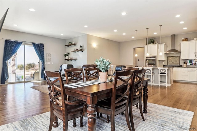 dining space with wood-type flooring