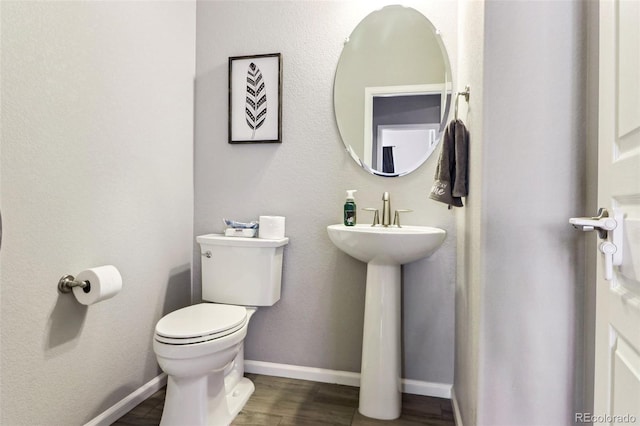 bathroom featuring wood-type flooring and toilet