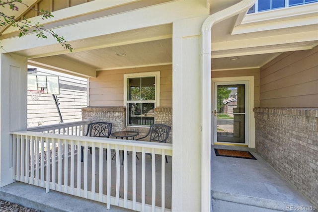5564 Kalispell St, Denver, CO 80239 - doorway to property with covered porch and brick siding