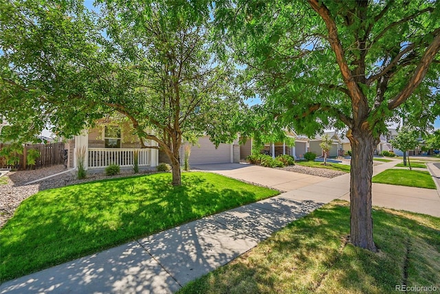 5564 Kalispell St, Denver, CO 80239 - view of property hidden behind natural elements featuring concrete driveway and a garage
