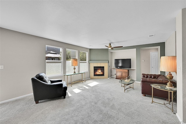 5564 Kalispell St, Denver, CO 80239 - carpeted living room with a tile fireplace and a ceiling fan