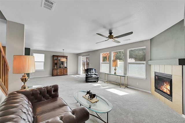 5564 Kalispell St, Denver, CO 80239 - living room with carpet, a ceiling fan, and a tile fireplace