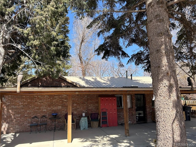 300 3rd St, Saguache, CO 81149 - view of property exterior featuring metal roof and brick siding