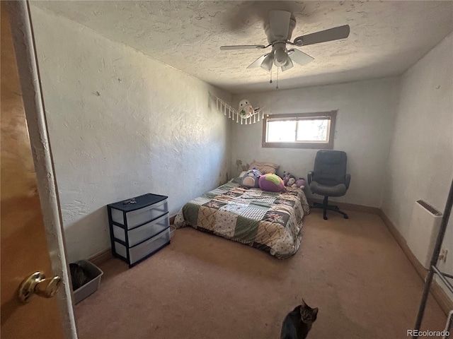 300 3rd St, Saguache, CO 81149 - carpeted bedroom featuring a ceiling fan, a textured ceiling, and a textured wall