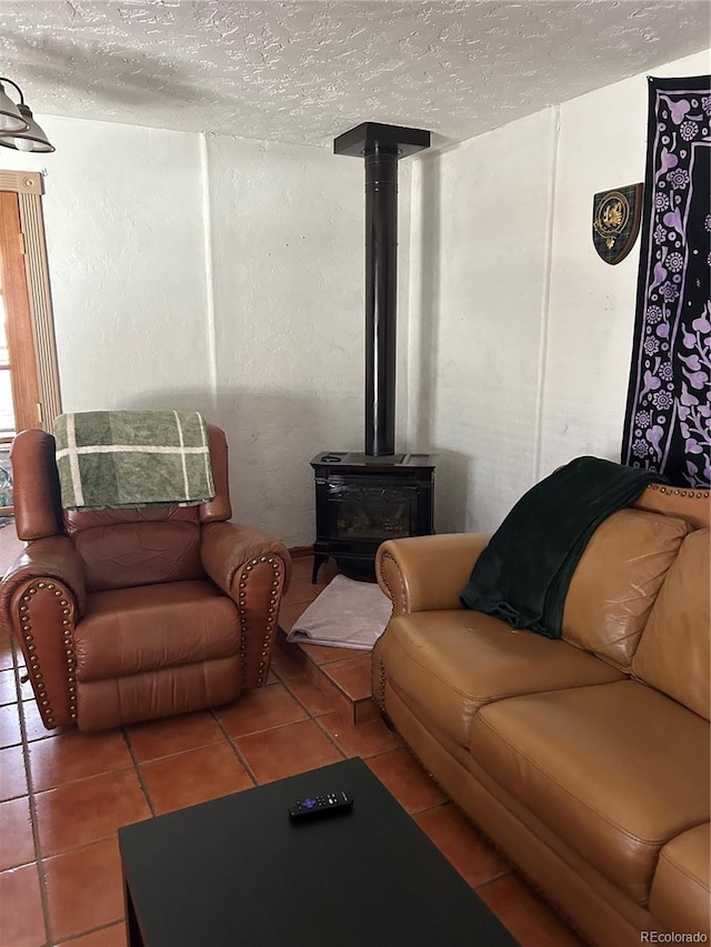 300 3rd St, Saguache, CO 81149 - tiled living area featuring a wood stove and a textured ceiling