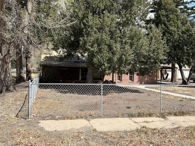 300 3rd St, Saguache, CO 81149 - obstructed view of property with brick siding and a fenced front yard
