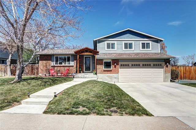 13915 W 73rd Ave, Arvada, CO 80005 - split level home with an attached garage, driveway, and brick siding