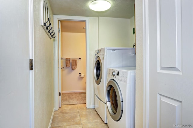 13915 W 73rd Ave, Arvada, CO 80005 - laundry area with washer and clothes dryer and light tile patterned floors