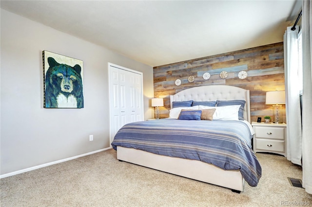 13915 W 73rd Ave, Arvada, CO 80005 - carpeted bedroom featuring wood walls, a closet, and an accent wall