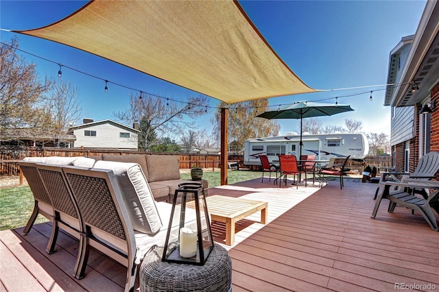 13915 W 73rd Ave, Arvada, CO 80005 - wooden terrace with outdoor dining area, a fenced backyard, and outdoor lounge area