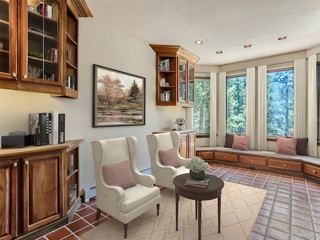 living area with a baseboard heating unit and recessed lighting