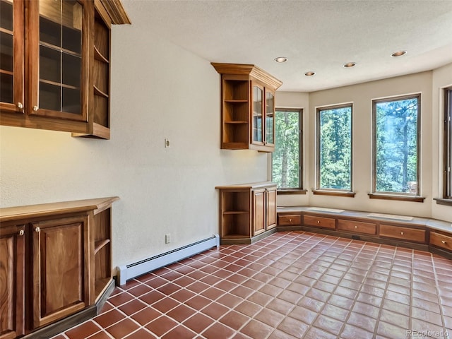 kitchen featuring glass insert cabinets, a baseboard heating unit, light countertops, recessed lighting, and open shelves