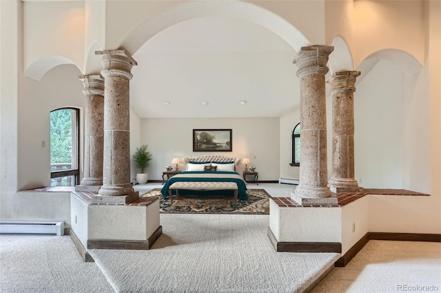 bedroom featuring decorative columns, carpet floors, baseboards, and a baseboard radiator