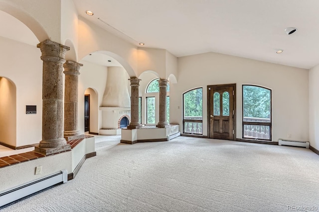 foyer with decorative columns, plenty of natural light, and baseboard heating