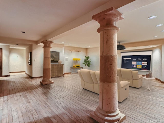 interior space featuring wood-type flooring, recessed lighting, baseboards, and ornate columns