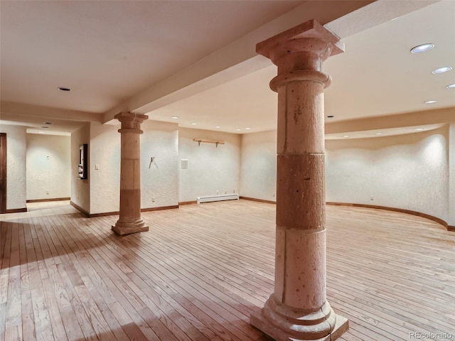 below grade area with hardwood / wood-style floors, recessed lighting, baseboards, and a baseboard radiator