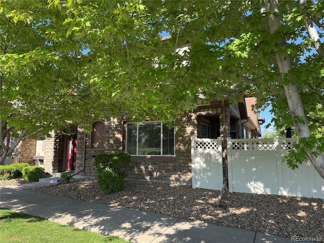 11307 Navajo Cir Unit A, Westminster, CO 80234 - obstructed view of property featuring stone siding