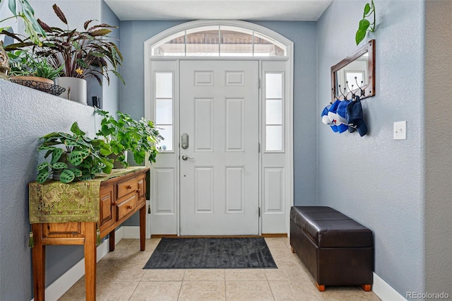 11307 Navajo Cir Unit A, Westminster, CO 80234 - entrance foyer with light tile patterned floors and a textured wall