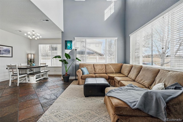 11307 Navajo Cir Unit A, Westminster, CO 80234 - living room featuring stone tile floors and a towering ceiling