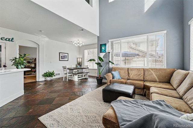 11307 Navajo Cir Unit A, Westminster, CO 80234 - living area featuring stone tile flooring and a towering ceiling