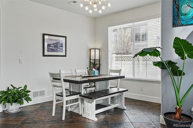 11307 Navajo Cir Unit A, Westminster, CO 80234 - dining room featuring stone tile flooring and a chandelier